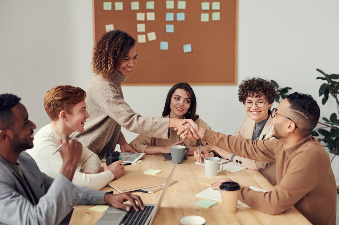 The Art of Drawing Readers In: Your attractive post title goes here Diverse team collaborating in a meeting, showcasing teamwork and cooperation in a modern workplace.