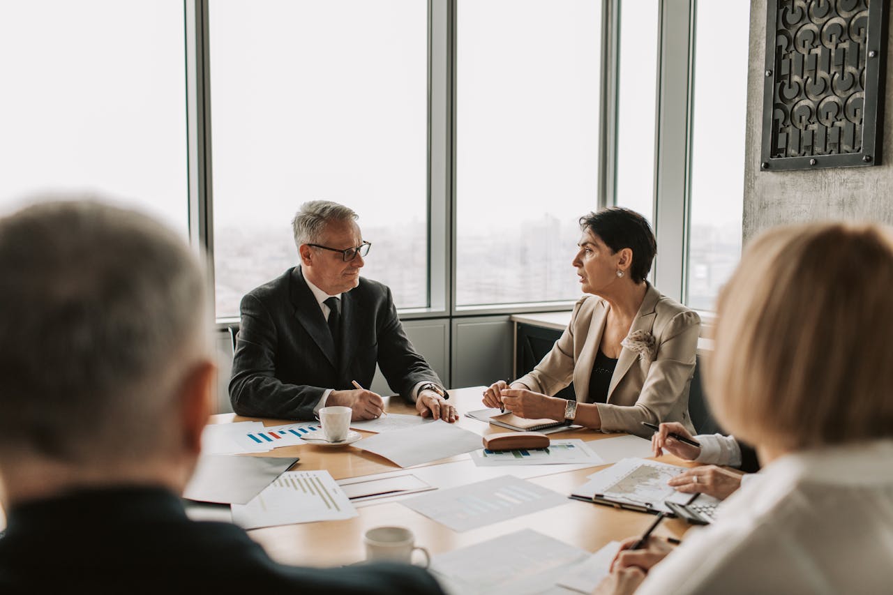 Mastering the First Impression: Your intriguing post title goes here Business professionals engaged in a strategic meeting in a modern office setting with natural light.